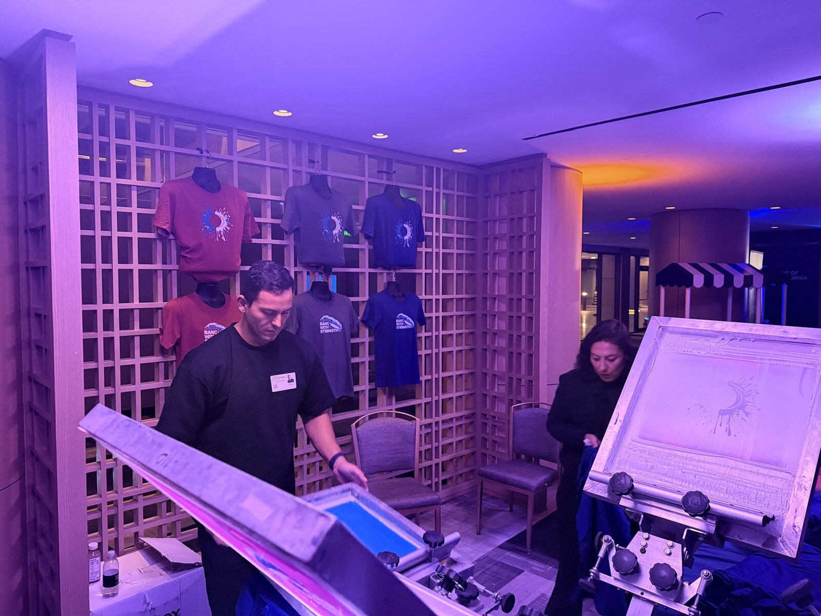Wall of finished event shirts on display