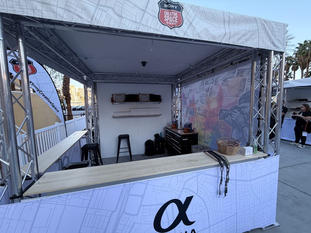 Festival crowd pressed up to a live Merch Troop tee-printing booth