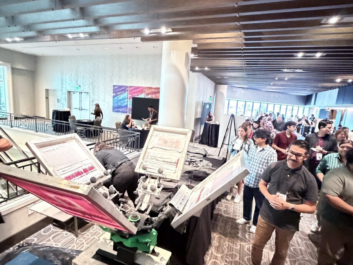 Guests queued along a live festival print booth